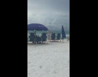 Blue bikini girl photographs black bikini friend 