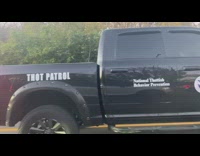 Pick up truck drives by with THOT Patrol sticker