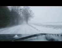 Car drive through harsh snow weather footage