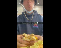 Asian Friend in Hoodie Aggressively Bites Sandwich