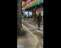 Woman slit dress model walk colorful banners