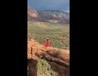 Woman red dress hold skirt devils bridge