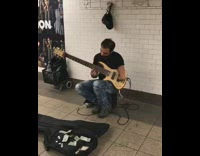 Guy with one hand plays guitar 