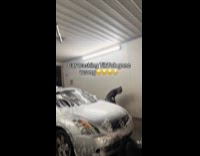 Man shirtless slides down at car wash