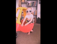 kid baby with glasses steps out of toy car