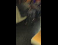 Man orange cape red hat plays saxophone on subway train