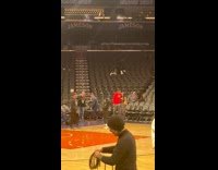 Collab IITW - Woman in black top poses with a man at the basketball arena