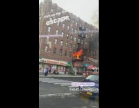 Fire breaks out in apartment building out of window next to fire escape