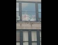 Nude images seen on tv in apartment through windows