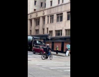 Construction worker sits on the hood of the cement truck to pose