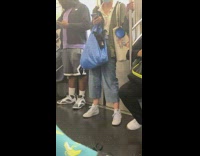 Woman carries blue bag with black dog inside of it 