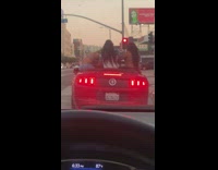 Three women bikini sit convertible car street