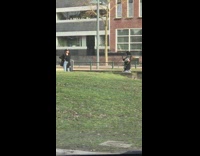 Girl black coat hand on hip grass