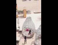 Two women bikini poses on poolside bed