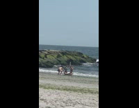 Two girls in bikini hold hands for photo 