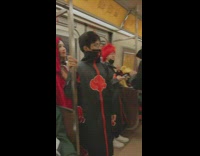 Group of people in black robes for halloween on subway