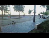 Guy grinds bike on seat, falls of and gets bicycle rans over by yellow train