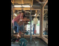 Guy exercises while carrying girl on back