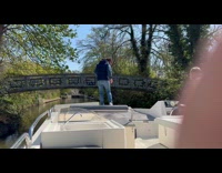 Man clings under bridge falls on water