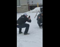 Guy poses with rake and truck in snow