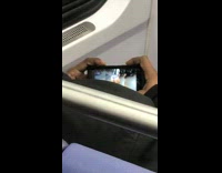 Man watches woman do squats at the gym on phone on subway train