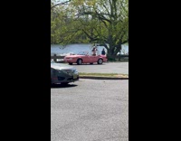 Collab IITW - Woman in pink dress poses inside the pink convertible car