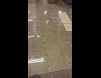 Woman shows flooded subway station after rainfall