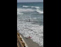 Woman jeans take selfie at beach waves