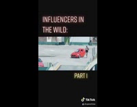 Guy walks around rooftop red car shorts 