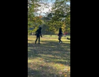 Two guys practice fencing on the park 