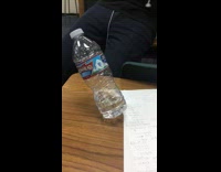 Guy throws flips water bottle leans sideways 