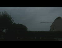 Slow motion lightning strike overcast shrubs house