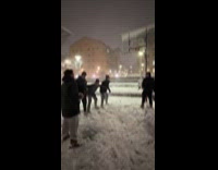 Man dribbles snow basketball and breaks