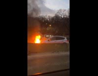Car burning huge fire on the road 