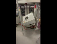 Person Walks in Train with Machine on Wheelbarrow