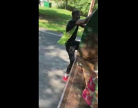 Guy rides trash truck 