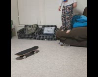 Little boy jumps off couch onto mini skateboard, slips and hits head on floor