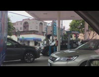 Man standing on car hood cleaning windshield 