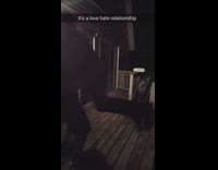 Guy bodyslams his friend onto wooden floor on their porch