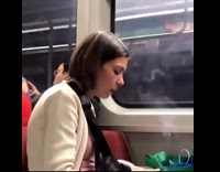 White jacket lady smokes inside subway 