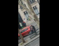 Woman in green dress hangs on the window grills
