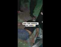 Guy carries girl away from guy passed out on ground 