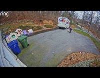 Delivery driver slides package through the door