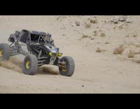 Dune buggy races down dirt trail
