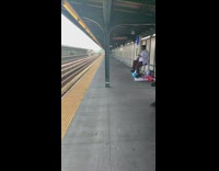 Woman rides blue white exercise bike at empty train station