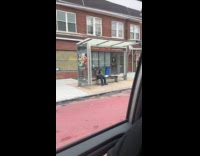Man on bus stop play green recorder