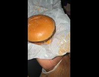 Woman shows burger with salt and pepper