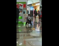Little kid rides panda toy across mall 