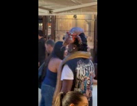 Man carries snake and lizard near restaurant