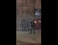 Man and woman pose in gray puffer jackets